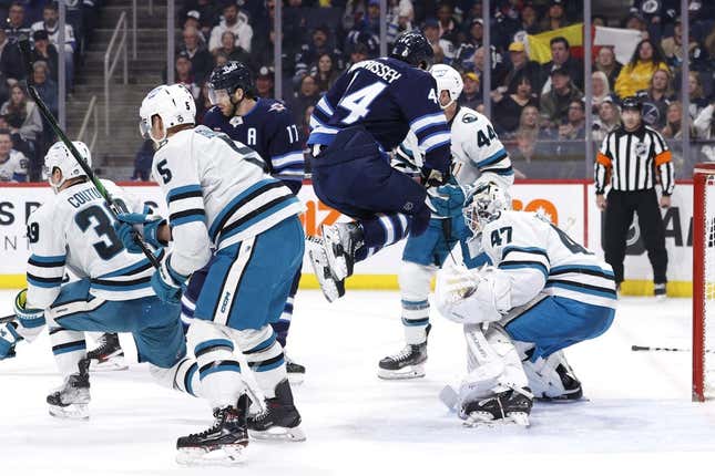 Mar 6, 2023; Winnipeg, Manitoba, CAN; Winnipeg Jets defenseman Josh Morrissey (44) leaps out of the way of a shot on San Jose Sharks goaltender James Reimer (47) in the second period at Canada Life Centre.