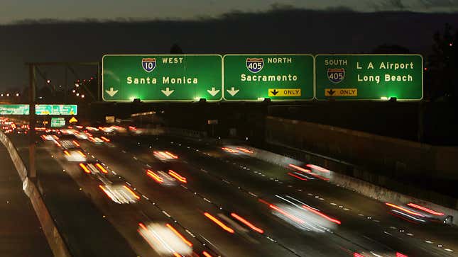 A set of green route destination signs over a California highway