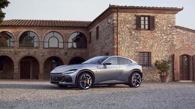 New Silver Ferrari Purosangue Crossover on a dirt driveway in front of a stone villa