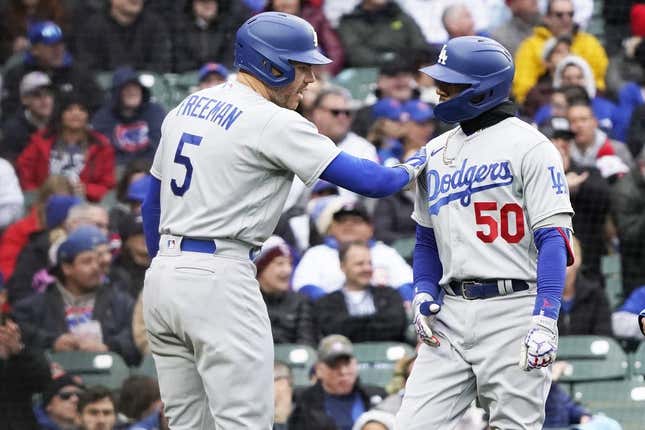 Apr 23, 2023; Chicago, Illinois, USA; Los Angeles Dodgers right fielder Mookie Betts (50) is greeted by first baseman Freddie Freeman (5) after hitting a two-run homer against the Chicago Cubs during the third inning at Wrigley Field.