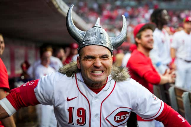 Cincinnati Reds’ Joey Votto celebrates in the dugout after hitting a solo home run in his season debut