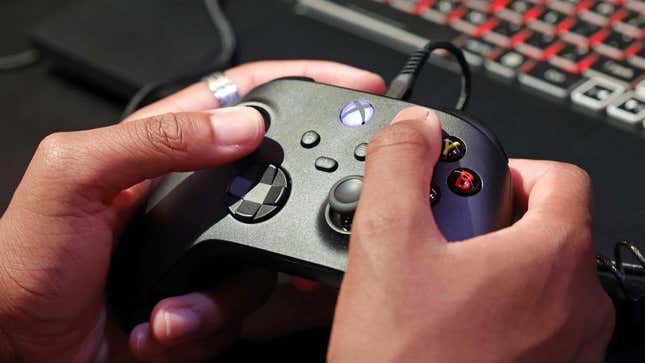 A person uses an Xbox controller.