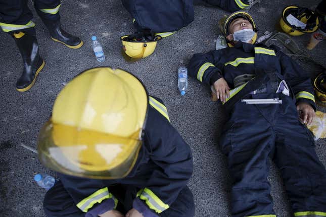 Firefighters take a break in Tianjin.