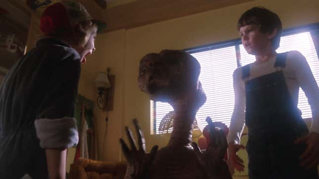 A little girl shrieks in horror at a shriveled, brown alien with a telescopic neck.