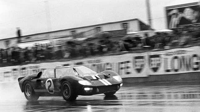 A black and white photo of a Ford GT racing at Le Mans. 