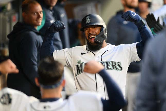 Apr 4, 2023; Seattle, Washington, USA; Seattle Mariners right fielder Teoscar Hernandez celebrates in the dugout after hitting a home run against the Los Angeles Angels during the fourth inning at T-Mobile Park.