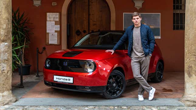 Formula 1 driver Max Verstappen poses with a special edition Honda E in red