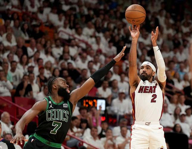 May 21, 2023; Miami, Florida, USA; Miami Heat guard Gabe Vincent (2) shoots against Boston Celtics guard Jaylen Brown (7) during the first half in game three of the Eastern Conference Finals for the 2023 NBA playoffs at Kaseya Center.