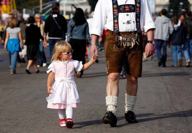 A young festival-goer walks with her father