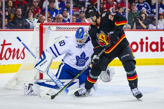 Mar 2, 2023; Calgary, Alberta, CAN; Toronto Maple Leafs goaltender Joseph Woll (60) makes a save against Calgary Flames center Elias Lindholm (28) during the second period at Scotiabank Saddledome.