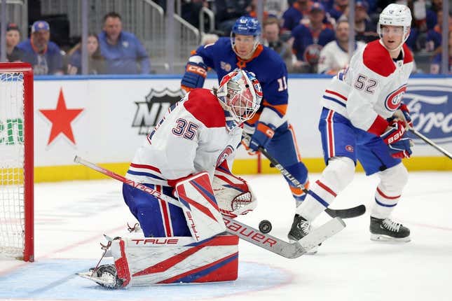 Apr 12, 2023; Elmont, New York, USA; Montreal Canadiens goaltender Sam Montembeault (35) makes a save in front of New York Islanders left wing Zach Parise (11) during the second period at UBS Arena.