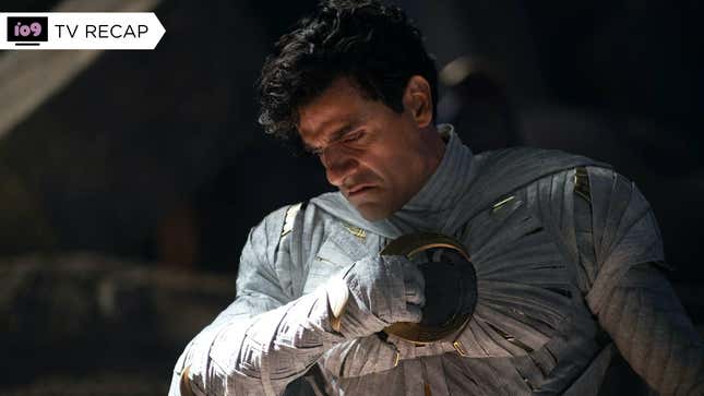 Oscar Isaac as Marc Spector, wearing his Moon Knight uniform without the mask and hood, as he grimaces, holding a crescent-shaped blade up to his chest.
