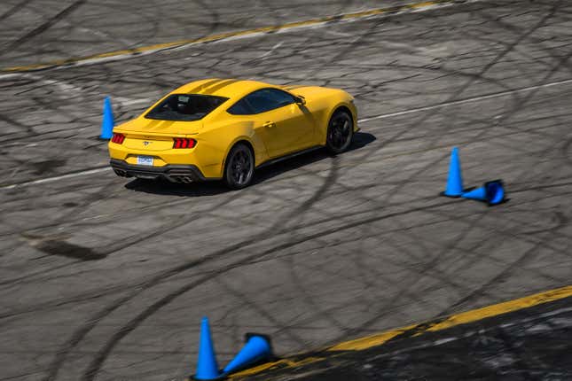 A yellow 2024 Ford Mustang EcoBoost on an autocross course at Irwindale Raceway in Irwindale, CA. 