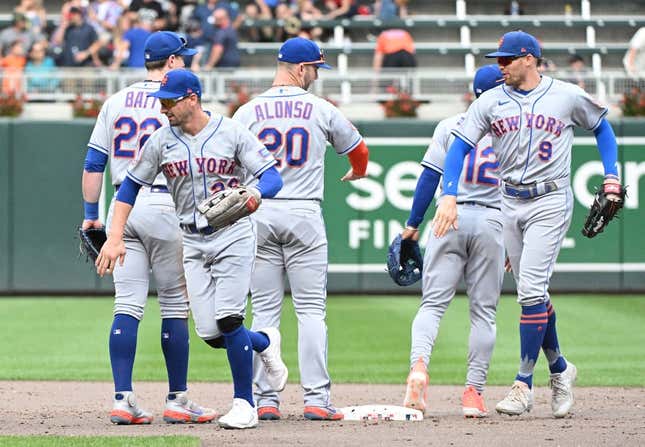 Sep 10, 2023; Minneapolis, Minnesota, USA; New York Mets left fielder Tim Locastro (26) and New York Mets center fielder Brandon Nimmo (9) celebrate a 2-0 win with their teammates at Target Field.