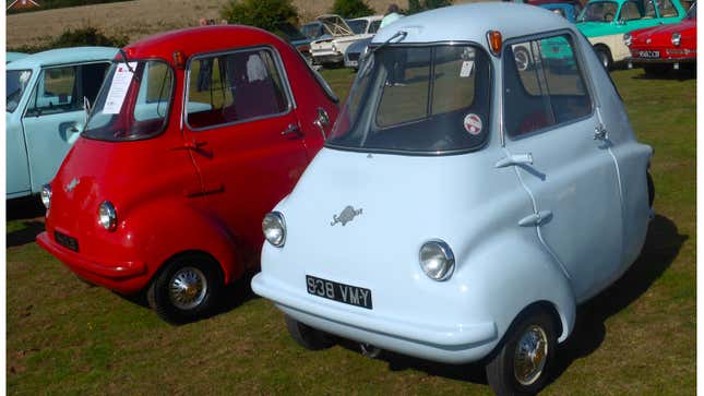 A photo of two Scootacars in a field. 