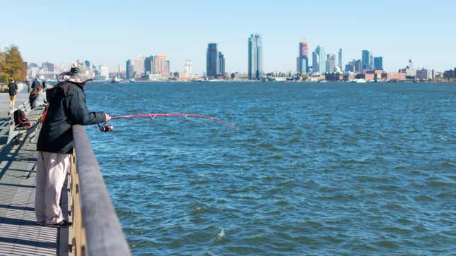 Man Fishing along the East River on the Lower East Side in New York City