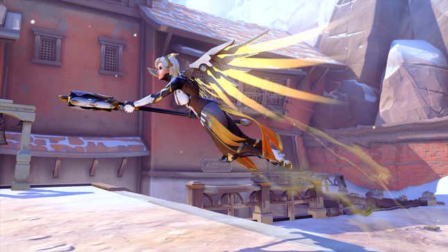 Mercy is shown flying over a snow-covered town with her staff raised and mechanical wings spread.