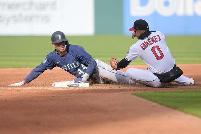 Apr 7, 2023; Cleveland, Ohio, USA; Seattle Mariners center fielder Julio Rodriguez (44) steals second as Cleveland Guardians second baseman Andres Gimenez (0) is late with the tag during the third inning at Progressive Field.