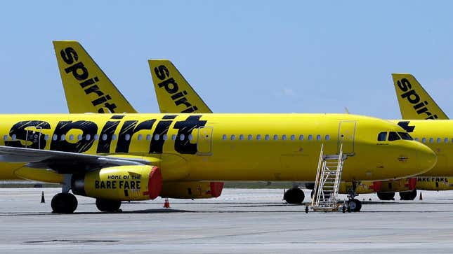  line of Spirit Airlines jets sit on the tarmac at the Orlando International Airport. A Spirit Airlines flight made an emergency landing after a person's battery caught on fire.