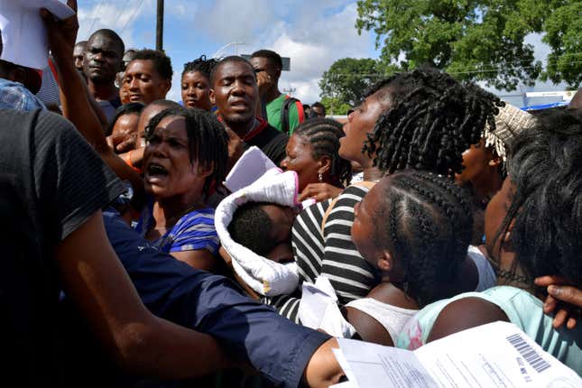 Migrants from Africa and Haiti try to enter an immigrant detention center in Tapachula, Mexico to request humanitarian visas to cross the country towards the United States, June 27, 2019.