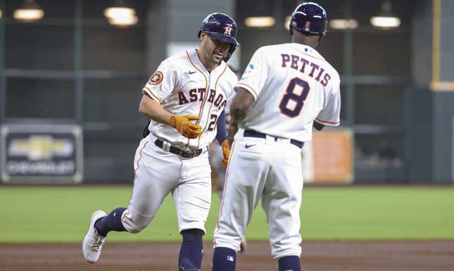 Apr 5, 2023; Houston, Texas, USA; Houston Astros center fielder Chas McCormick (20) celebrates with third base coach Gary Pettis (8) after hitting a home run during the second inning against the Detroit Tigers at Minute Maid Park.