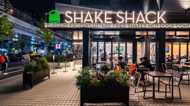 Outside of Shake Shack restaurant at night