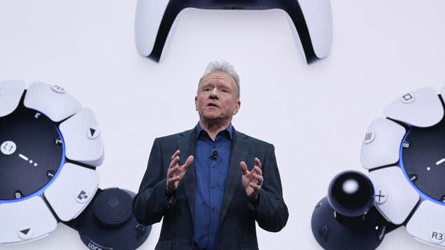 Sony CEO Jim Ryan is standing in front of PlayStation controllers during a CES 2023 event in Las Vegas.