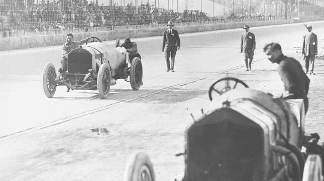 Ralph DePalma (L) and his riding mechanic Rupert Jeffkins (R) pushing their Mecedes down the front straight