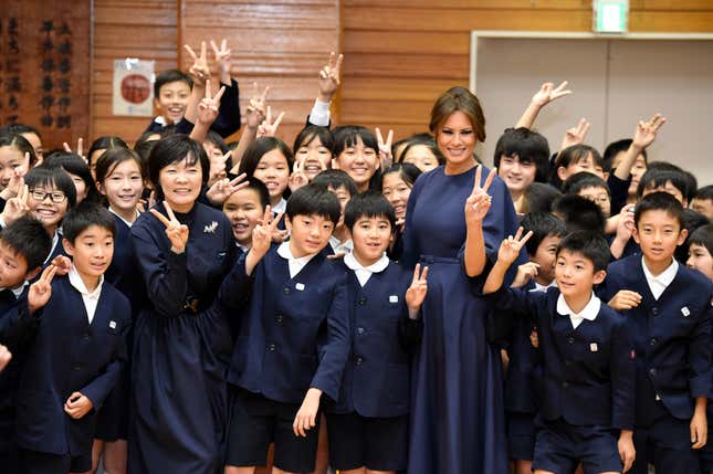 Melania Trump poses for a photo with students as they visit the Kyobashi Tsukiji elementary school in Tokyo, Japan, Nov. 6 2017.