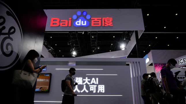 People stand by a sign of Baidu during World Artificial Intelligence Conference, following the coronavirus disease (COVID-19) outbreak, in Shanghai.