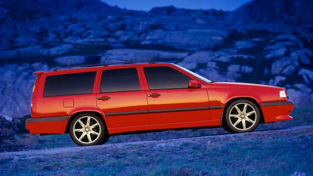 A sporty red Volvo 850 R station wagon in a field