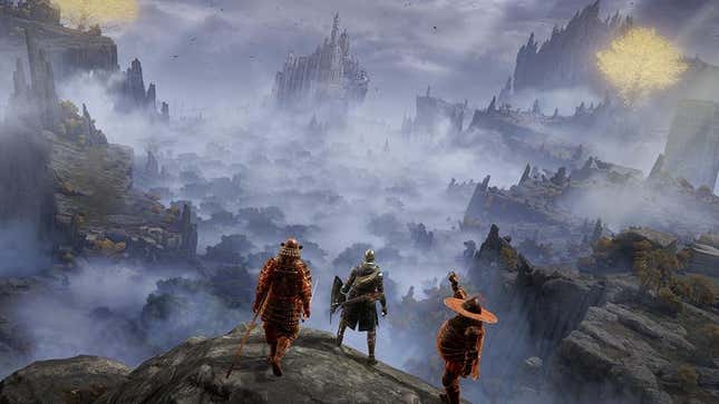 Three Elden Ring warriors stand on a cliff overlooking a foggy valley that leads to a castle. 