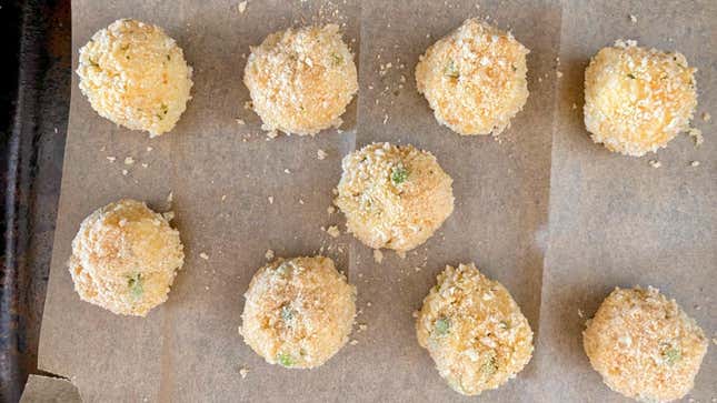Cauliflower arancini rolled and breaded, ready to fry.