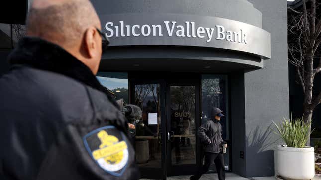 A security guard watches a customer leave a Silicon Valley Bank office on March 13, 2023 in Santa Clara, California. Days after Silicon Valley Bank collapsed, customers are lining up to try and retrieve their funds from the failed bank. The Silicon Valley Bank failure is the second largest in U.S. history.
