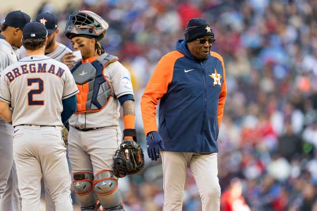 Apr 7, 2023; Minneapolis, Minnesota, USA; Houston Astros manager Dusty Baker Jr. (12) walks back to the dugout after handing Houston Astros relief pitcher Bryan Abreu (52) the ball in the sixth inning at Target Field.