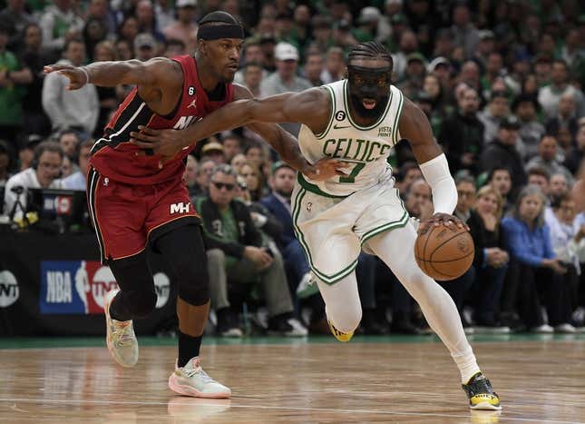 May 17, 2023; Boston, Massachusetts, USA; Boston Celtics guard Jaylen Brown (7) dribbles against Miami Heat forward Jimmy Butler (22) during the second half in game one of the Eastern Conference Finals for the 2023 NBA playoffs at TD Garden.