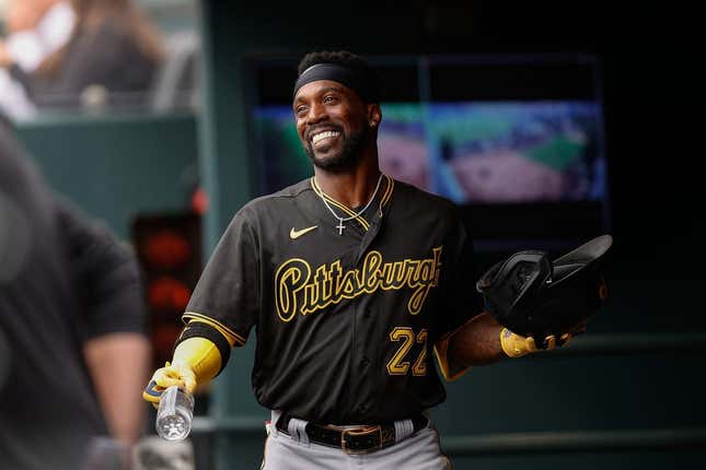 Apr 19, 2023; Denver, Colorado, USA; Pittsburgh Pirates designated hitter Andrew McCutchen (22) reacts in the dugout after hitting a solo home run in the second inning against the Colorado Rockies at Coors Field.