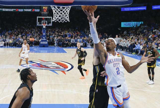 Mar 7, 2023; Oklahoma City, Oklahoma, USA; Oklahoma City Thunder guard Shai Gilgeous-Alexander (2) goes to the basket in front of Golden State Warriors guard Klay Thompson (11) during the first half at Paycom Center. Oklahoma City won 137-128.