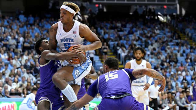 James Madison’s Xavier Brown forces a turnover as he ties up UNC’s Armando Bacot.