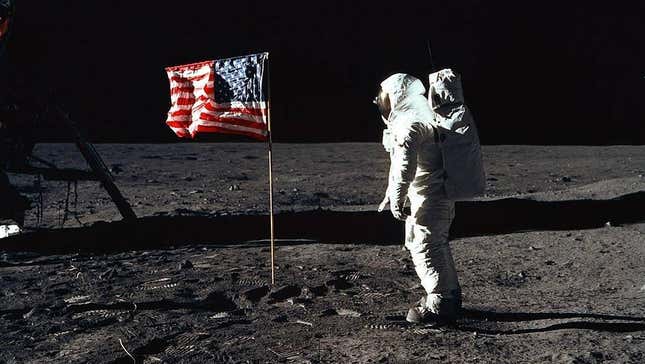 Astronaut Edwin Aldrin Jr. poses for a photograph next to the deployed United States flag during an Apollo 11 extravehicular activity (EVA) on the lunar surface.