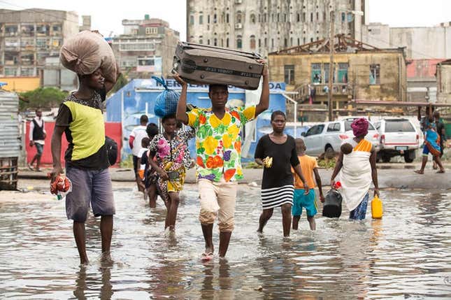 People leaving their homes in the flooded section of Praia Nova, Beira, Mozambique in the wake of tropical cyclone Idai.