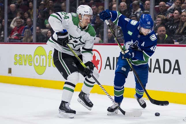 Mar 14, 2023; Vancouver, British Columbia, CAN; Dallas Stars forward Roope Hintz (24) stick checks Vancouver Canucks forward Elias Pettersson (40) in the second period at Rogers Arena.