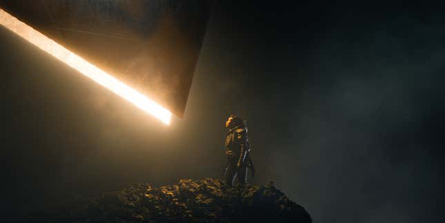 A woman stands beneath a glowing structure in a scene from Apple TV+ sci-fi series Foundation.