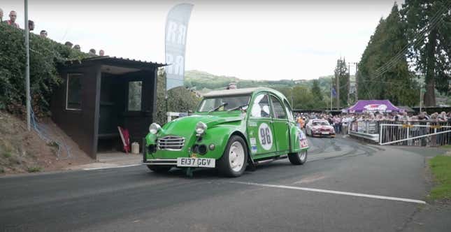A bright green Citroen 2CV race car lines up at the starting line.