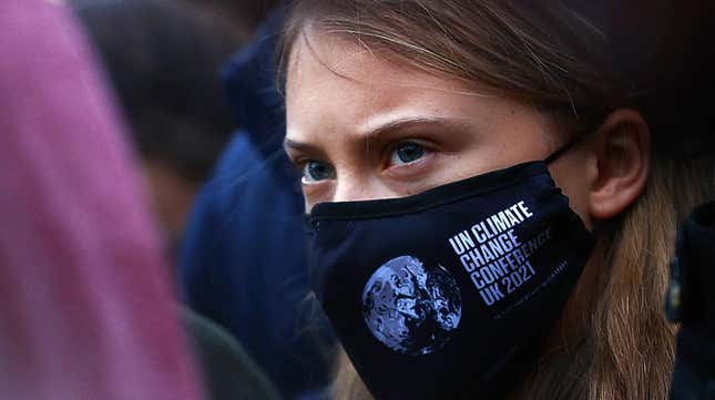 A closeup shot of Swedish climate activist Greta Thunberg as she takes part in a protest at Festival Park in Glasgow wearing a COP26 mask.