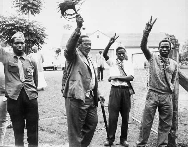 Kenya’s independence leader Jomo Kenyatta, second left, acknowledges cheers from followers at his home at Gatundu, near Nairobi (Aug. 21, 1961).