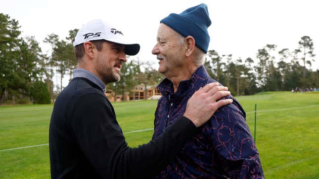 Aaron Rodgers (l.) and Bill Murray greet each other on the sixth hole during the first round of the AT&amp;T Pebble Beach Pro-Am.