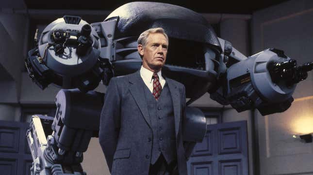Ronny Cox as Dick Jones, standing in front of his creation, the ED-209, in Paul Verhoeven’s Robocop.