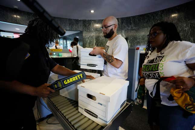 Activists deliver dozens of boxes full of signed petitions to Atlanta City Hall, Monday, Sept. 11, 2023, to force a referendum on the future of a planned police and firefighter training center. Shortly after, though, Atlanta officials refused to accept the paperwork for processing, saying the city is awaiting a court decision over whether the petitions had been turned in on time. 