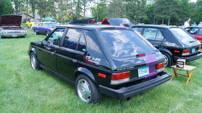 A photo of a black Dodge Omni. 